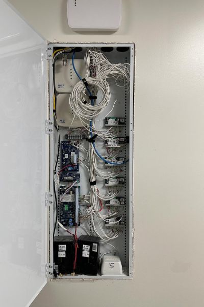 Open electrical panel with neatly organized wiring and electronic components.