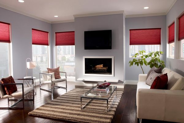 blue honeycomb shades on a window overlooking the ocean