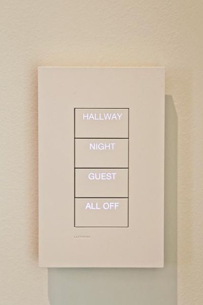 Wall switch with backlit labels for various lighting modes, including Hallway, Night, Guest, and All Off.