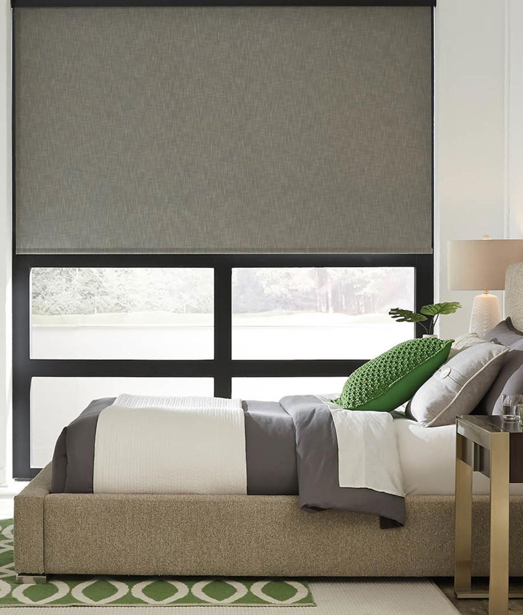 Stylish bedroom with roller shades and modern decor.