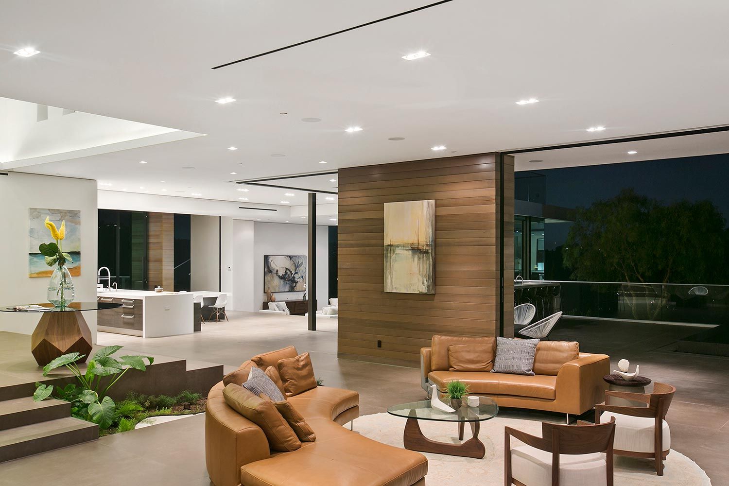 A stylish living room featuring a modern audio system with in-ceiling speakers.